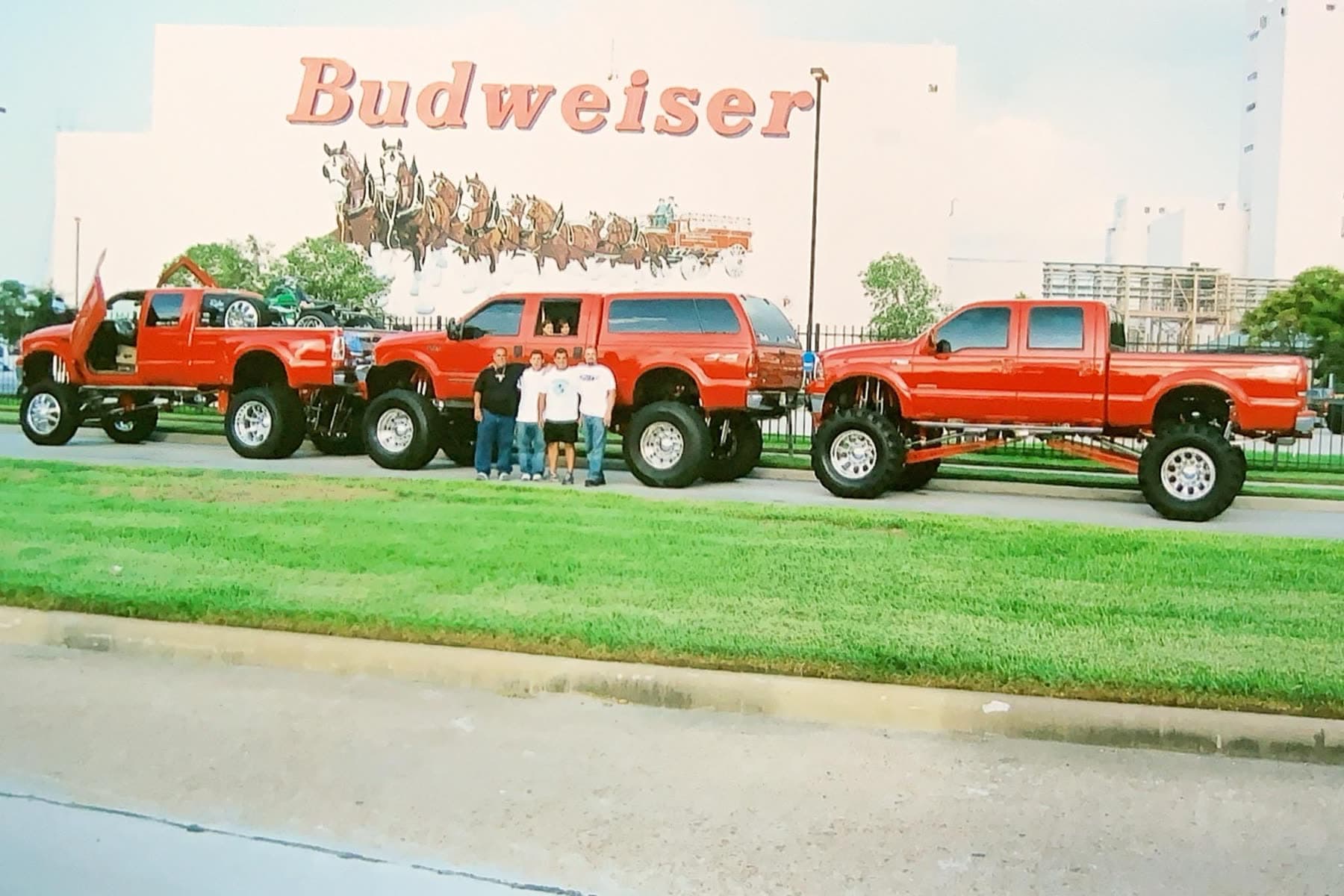 Lineup of red custom trucks on display